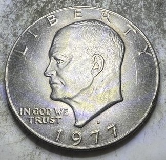 Close-up of 1977 Eisenhower dollar doubled die obverse showing doubling on date numerals or LIBERTY inscription under magnification